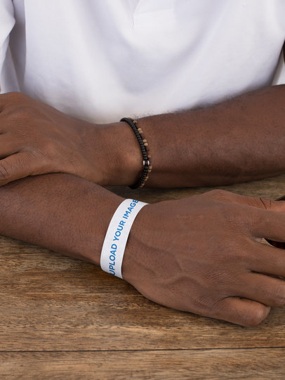 Paper Wristband Mockup of a Man at a Table 