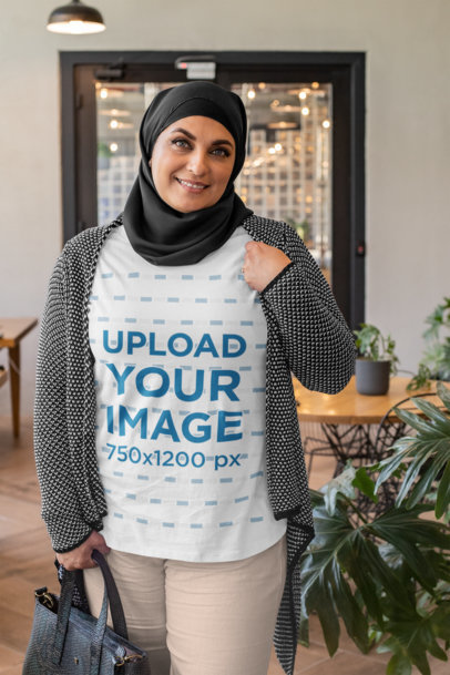T-Shirt Mockup of a Woman With a Hijab Holding Her Purse