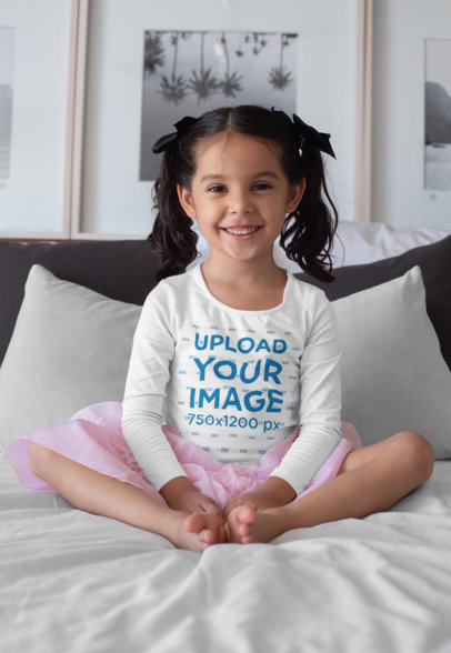 Mockup of a Girl Wearing a Long Sleeve Tee Sitting in Bed