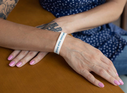 Mockup of a Tattooed Woman Wearing a Silicone Wristband