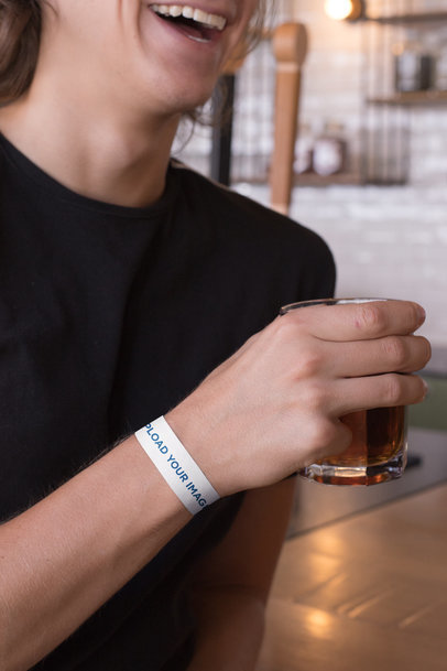 Paper Wristband Mockup of a Smiling Man Having a Drink