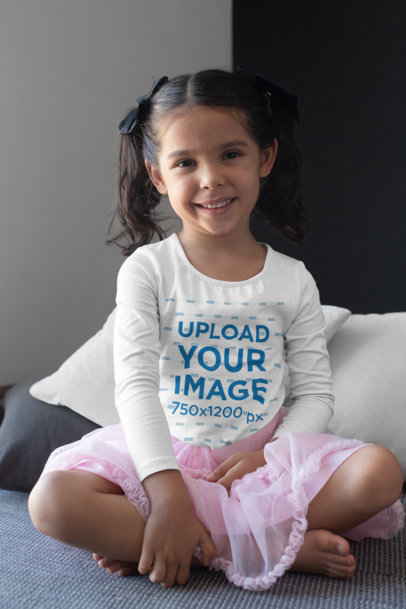 Long Sleeve T-Shirt Mockup of a Girl Sitting Cross-Legged and Smiling