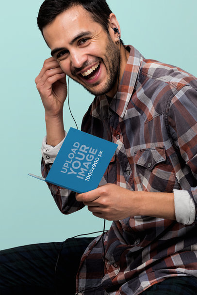 Digipak Mockup Featuring a Smiling Man Listening to Music 