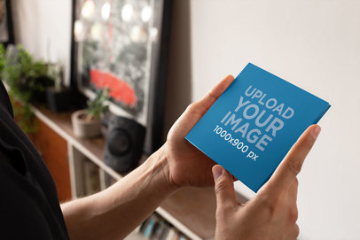Mockup of a Man Holding a Digipak 28355