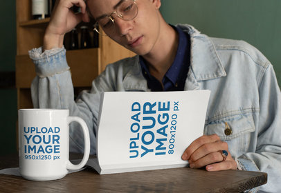 Mockup of a Young Man Reading a 15 oz Book with a Coffee Mug by His Side