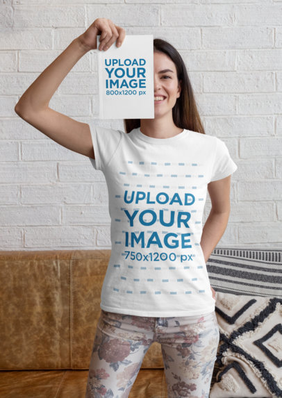 Mockup of a Woman Wearing a T-Shirt While Covering Her Face with a Book 