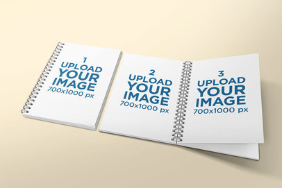 Mockup Featuring an Open A5 Notebook Lying Next to a Closed One 309-el