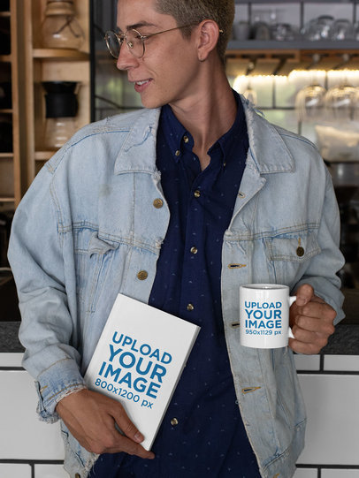 Mockup of a Hipster Man Holding a Coffee Mug and a Book 28464