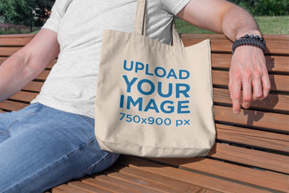 Tote Bag Mockup Featuring a Man Sitting on a Wooden Bench 195-el