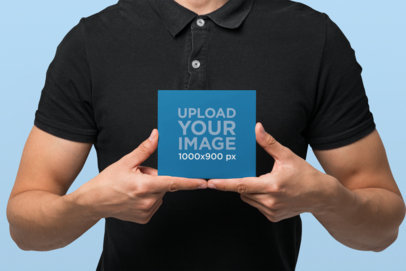 Mockup of a Man Holding a Digipak with Both Hands 