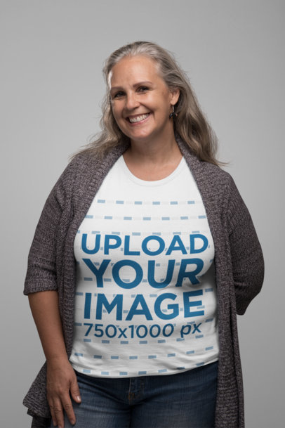 T-Shirt Mockup Featuring a Smiling Senior Woman in a Studio 