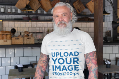 T-Shirt Mockup of a Bearded Senior with Tattooed Arms