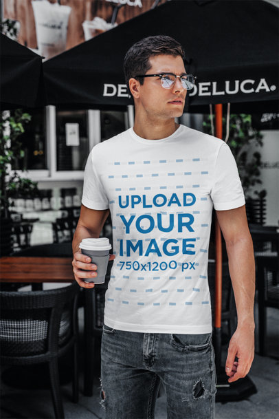 T-Shirt Mockup Featuring a Young Man with Glasses Drinking Coffee 