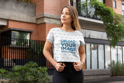 Sublimated Crop Top Mockup Featuring a Young Woman on a Street 
