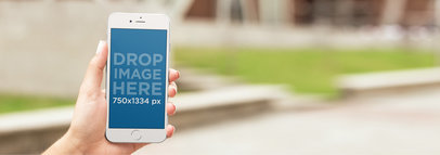 Mockup of a Woman at a Park Using an iPhone 7
