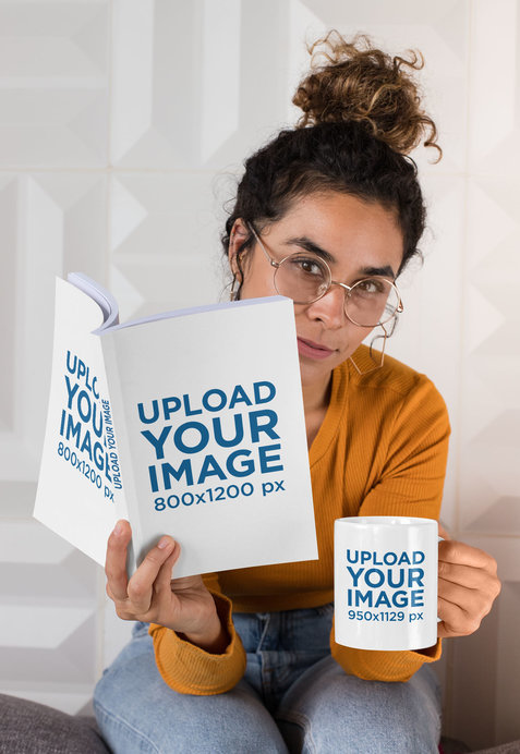 Mockup of a Woman With Glasses Holding an 11 oz Mug and a Book