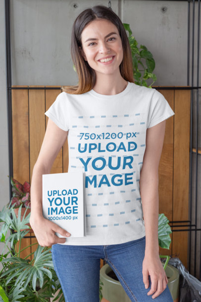T-Shirt Mockup of a Woman Holding a Book in a Room with Plants