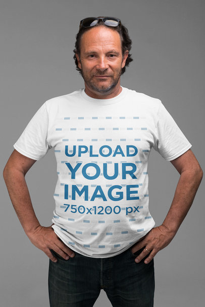 T-Shirt Mockup of a Serious Man Posing Against a Plain Background