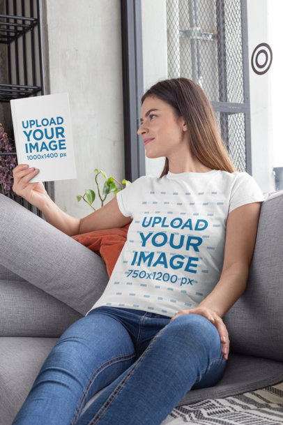 T-Shirt Mockup of a Woman Sitting on a Couch While Reading a Book 