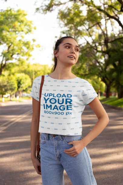 Crop Top Mockup Featuring a Young Woman in a Street Full of Trees