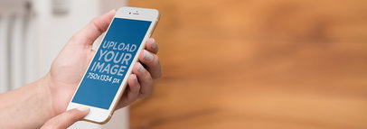 iPhone Mockup in Front of a Wooden Blurry Background