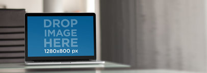 Mockup of a Macbook Pro on a Desk at an Office Environment