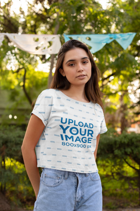 Mockup of a Woman Wearing a Cropped T-Shirt at the Park