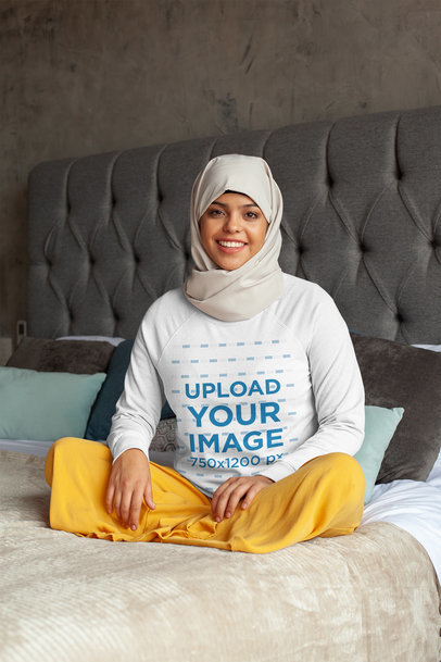 Crewneck Sweatshirt Mockup Featuring a Woman Wearing a Hijab on a Bed 