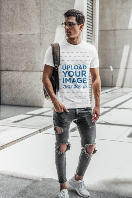 T-Shirt Mockup of a Man with Glasses Carrying a Backpack on His Shoulder