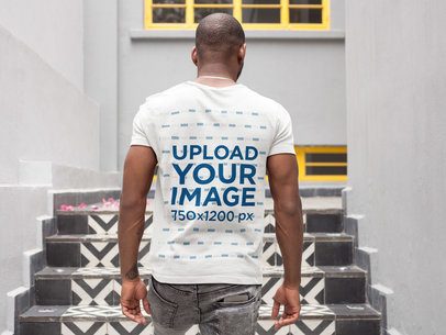 Back of a Man Walking Up a Mosaic Stairway Wearing a T-Shirt Mockup a9355b