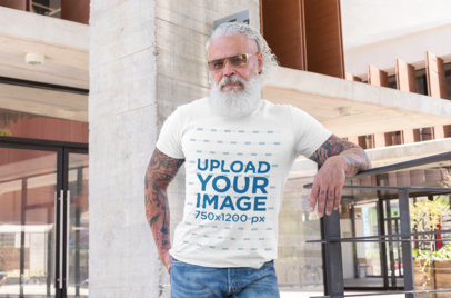 T-Shirt Mockup Featuring a Tattooed Senior Man with Sunglasses