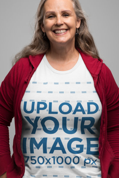 T-Shirt Mockup Featuring a Smiling Senior Woman in a Studio