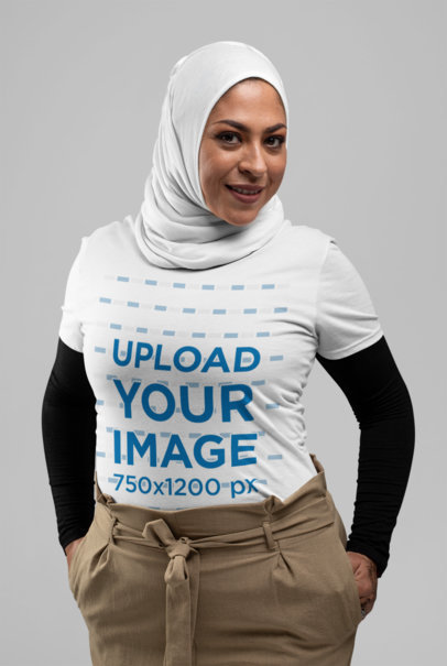 T-Shirt Mockup Featuring a Woman with a Hijab in a Studio