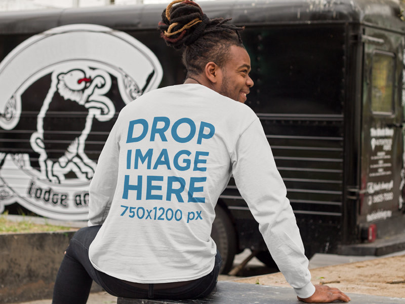 Back-view of a Man Wearing a Long Sleeve Tee Mockup Sitting Outdoors