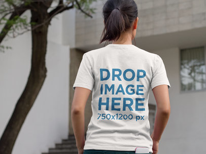 Mockup of a Woman from the Back Wearing a Tshirt on the Street