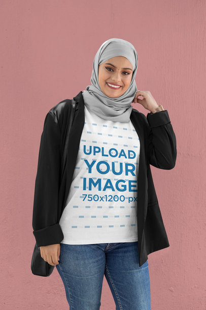 T-Shirt Mockup of a Woman Wearing a Hijab Against a Customizable Background 