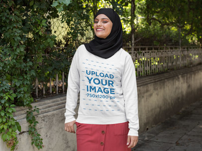Crewneck Sweatshirt Mockup of a Woman with a Hijab Walking on the Street