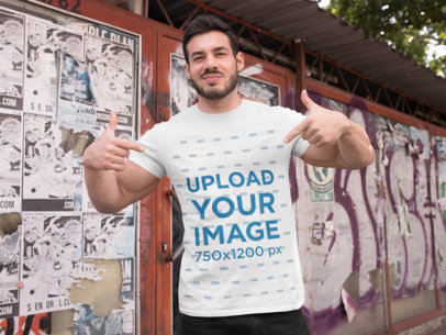 T-Shirt Mockup of a Fitness Man Posing Against a Wall with Posters 