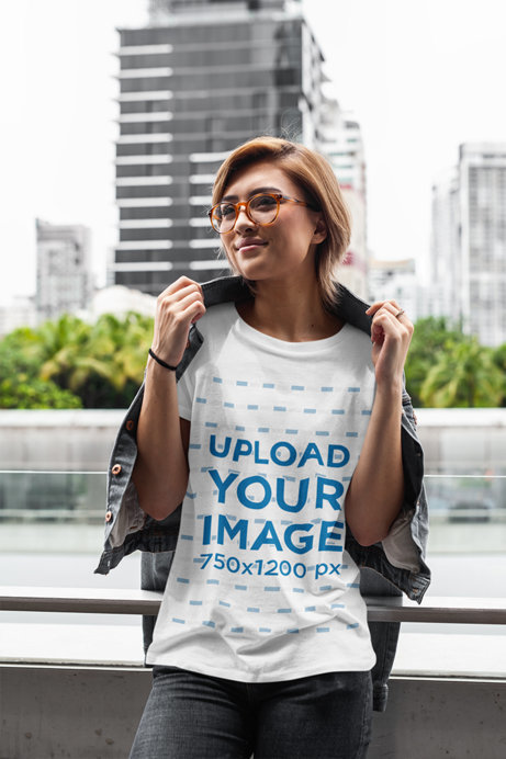 T-Shirt Mockup of a Joyful Woman Posing by a City Street 