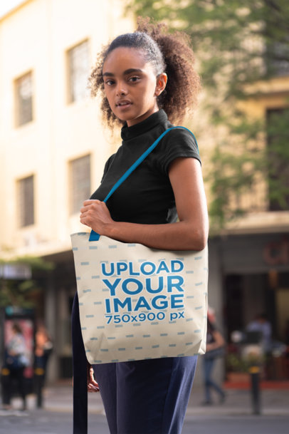 Mockup of a Woman with Kinky Hair Carrying a Tote Bag on Her Shoulder