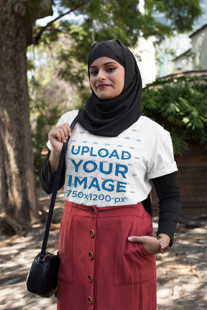T-Shirt Mockup of a Smiling Woman in a Hijab at a Park