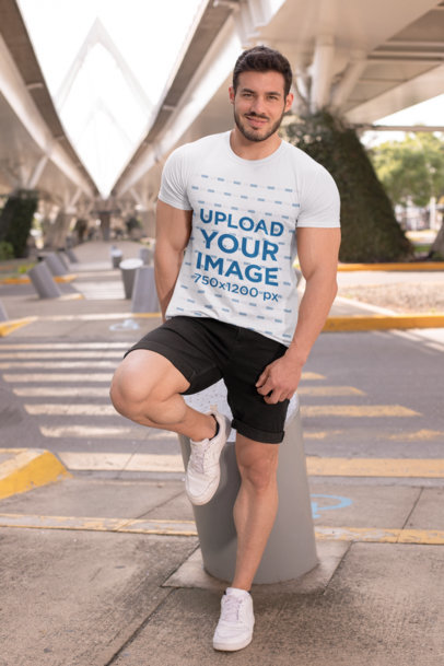 T-Shirt Mockup Featuring a Fit Man Under a City Bridge