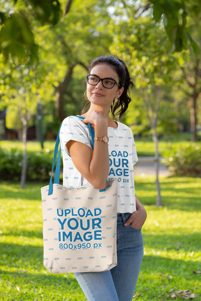 Crop Top Mockup of a Woman at a Park Carrying a Tote Bag with a Customizable Strap 28864