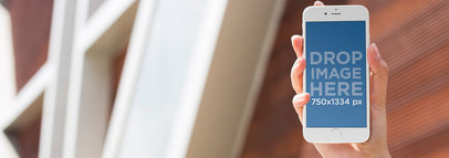 iPhone Mockup in Front of New Modern Building