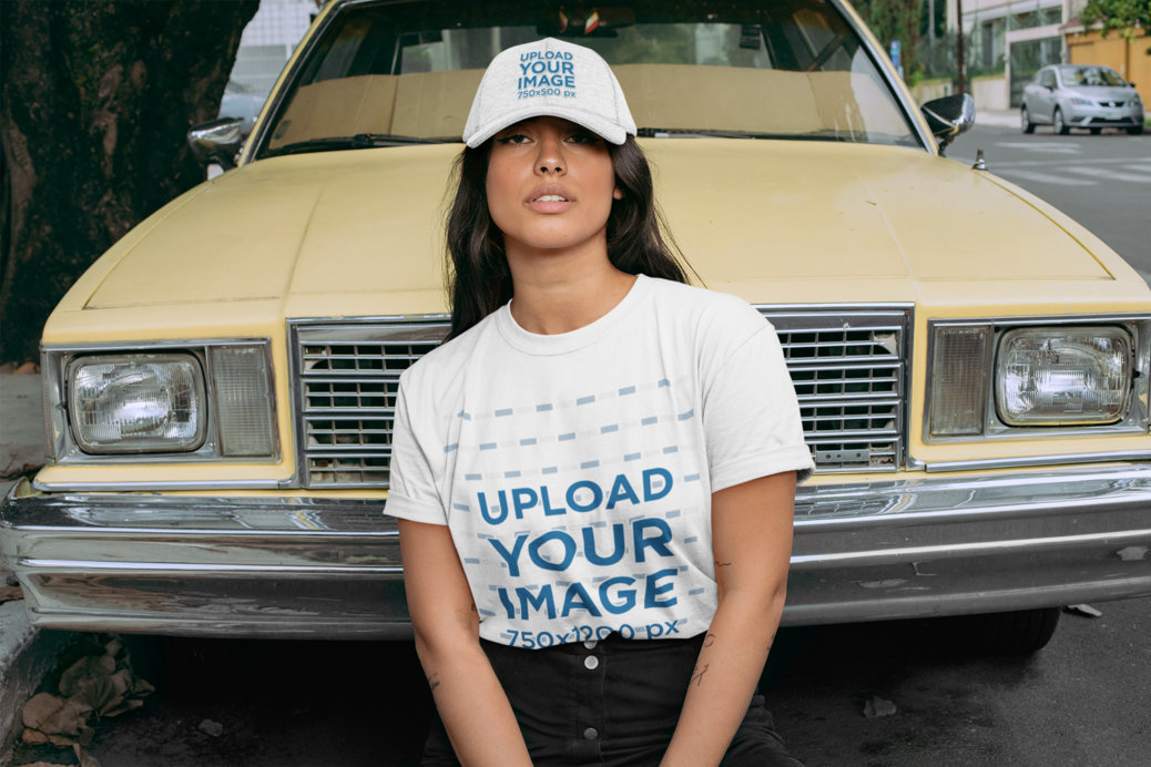 Crewneck T-Shirt Mockup of a Woman with a Dad Hat Posing in Front of an Old Car