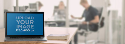 Macbook Mockup on a Table in an Office Environment