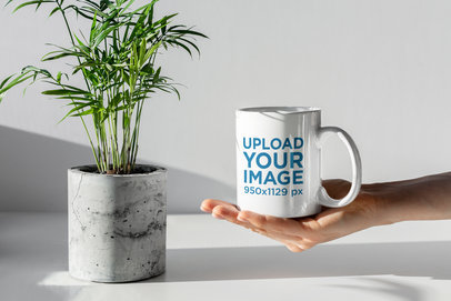Mockup Featuring a Hand Holding an 11 oz Coffee Mug in a Minimal Setting 