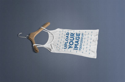 Tank Top Mockup Featuring a Wooden Hanger and a Solid Color Background 