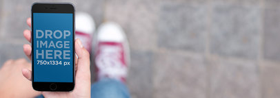 iPhone Mockup of a Woman on the Street Texting a Friend