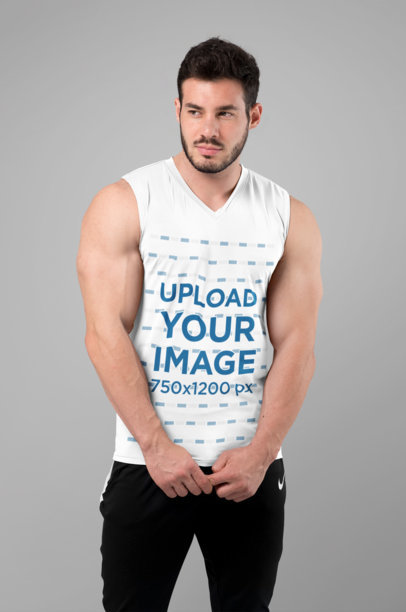 Sleeveless Shirt Mockup Featuring a Muscular Man Posing at a Studio 
